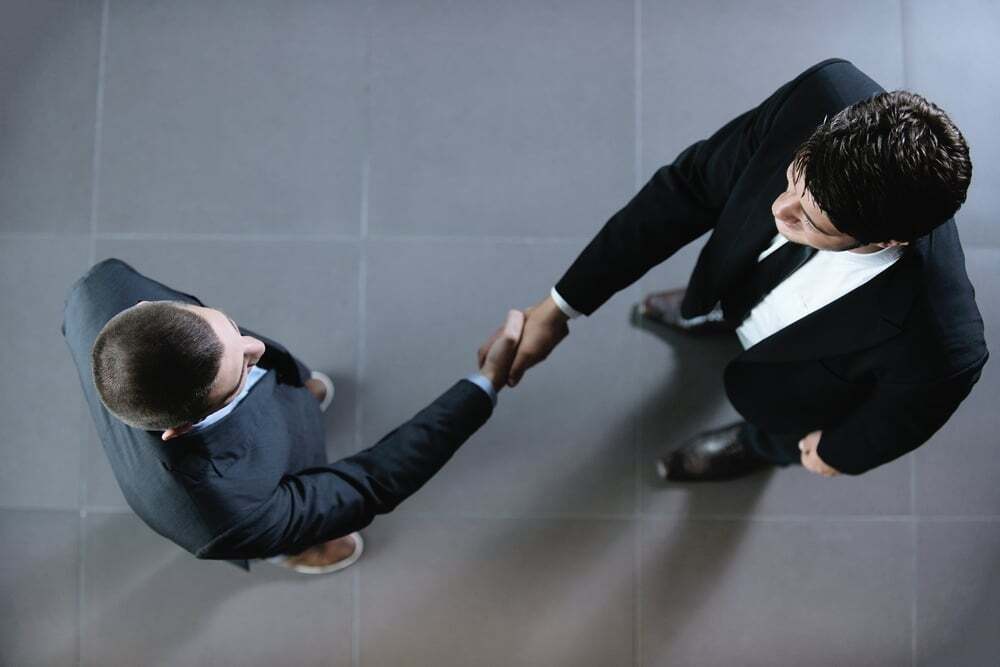 business people shaking hands make deal and sign contract-1